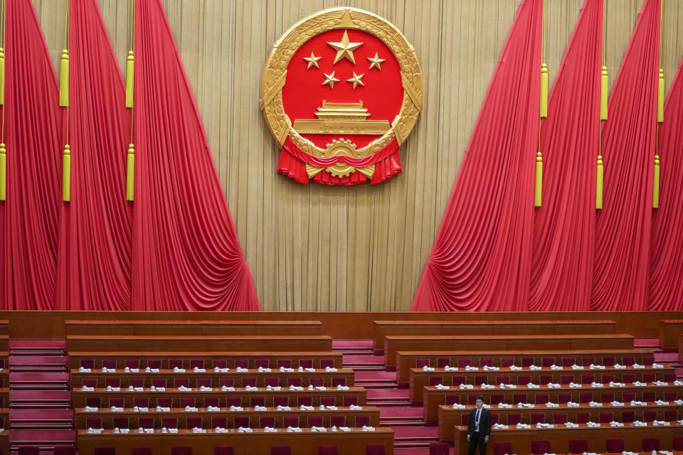 An official prepares prior to the second plenary session meeting of the National People's Congress (NPC) in the Great Hall of the People in Beijing, China, Friday, March 8, 2024. (AP Photo/Tatan Syuflana).