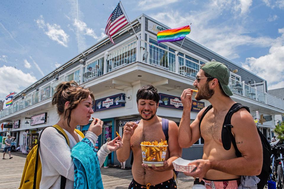 Visitors enjoy Thrasher's french fries on the boardwalk in Rehoboth Beach, Delaware.