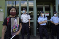 Chan Po-ying, a 66-year-old veteran pro-democracy activist, holds a picture of detained Chinese human rights activist, outside the Chinese liaison office in Hong Kong on Oct. 1, 2020. When the British handed its colony Hong Kong to Beijing in 1997, it was promised 50 years of self-government and freedoms of assembly, speech and press that are not allowed Chinese on the Communist-ruled mainland. As the city of 7.4 million people marks 25 years under Beijing's rule on Friday, those promises are wearing thin. Hong Kong's honeymoon period, when it carried on much as it always had, has passed, and its future remains uncertain, determined by forces beyond its control. (AP Photo/Kin Cheung)