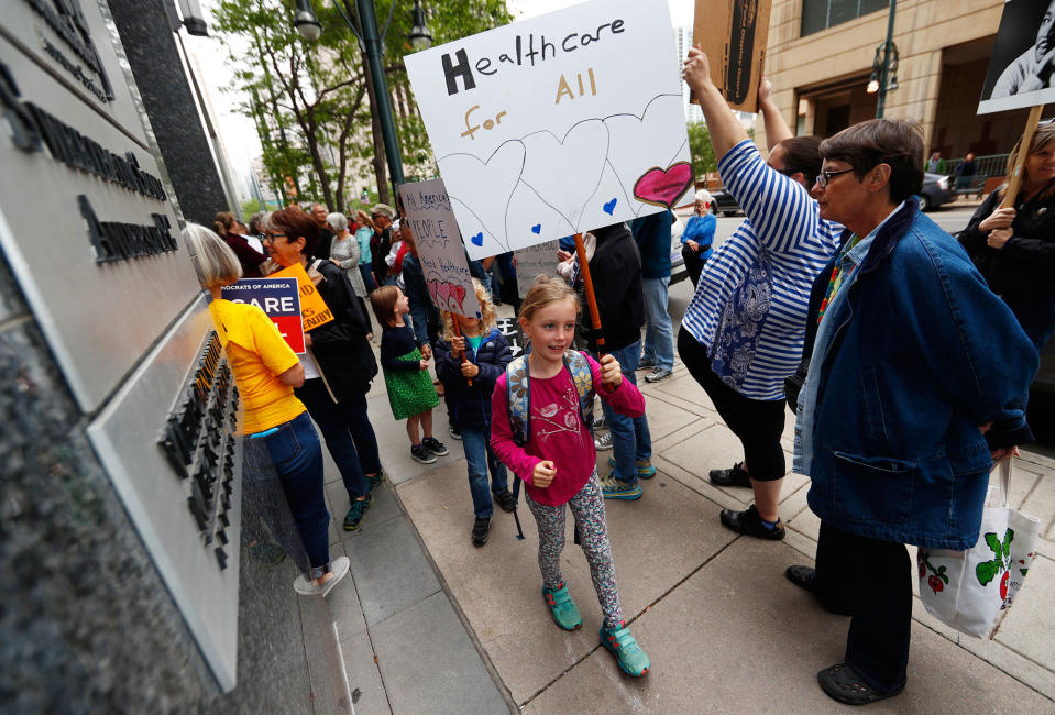 <p>People march during a protest against the Republican health bill unveiled in the U.S. Senate to dismantle the Affordable Care Act on Friday, June 23, 2017, in downtown Denver. More than 100 protesters crowded the sidewalk outside the building in which Sen. Cory Gardner, R-Colo., has his office. (Photo: David Zalubowski/AP) </p>