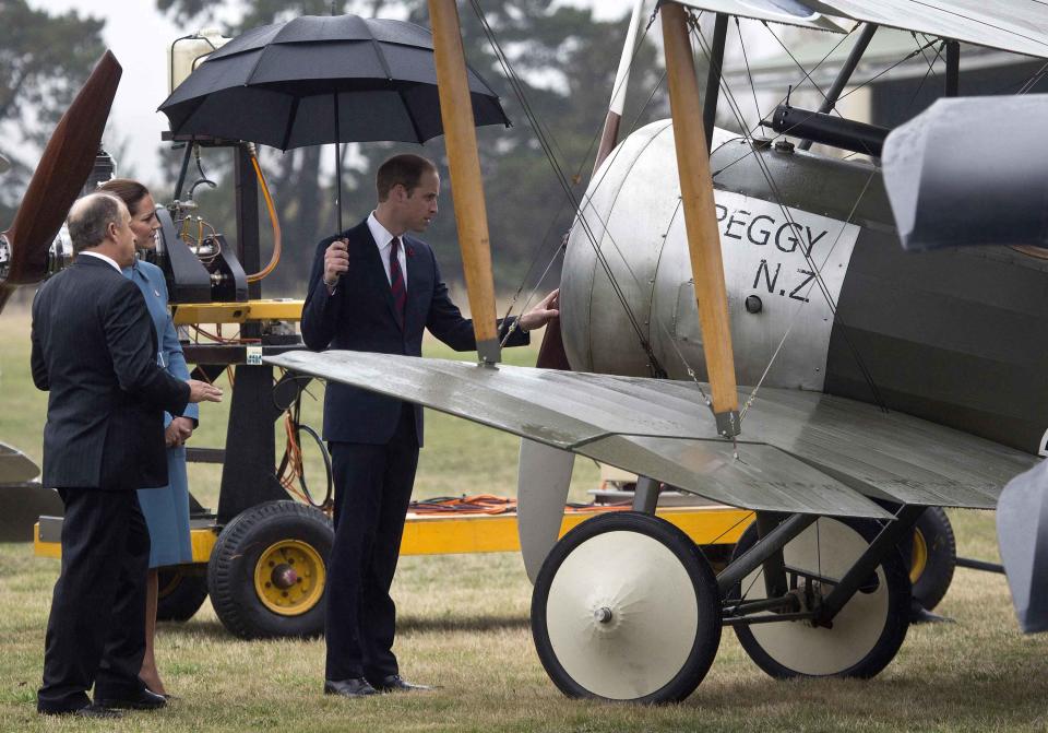 Britain's Prince William touches a vintage plane as his wife Catherine, the Duchess of Cambridge, looks on at the Omaka Aviation Heritage Center