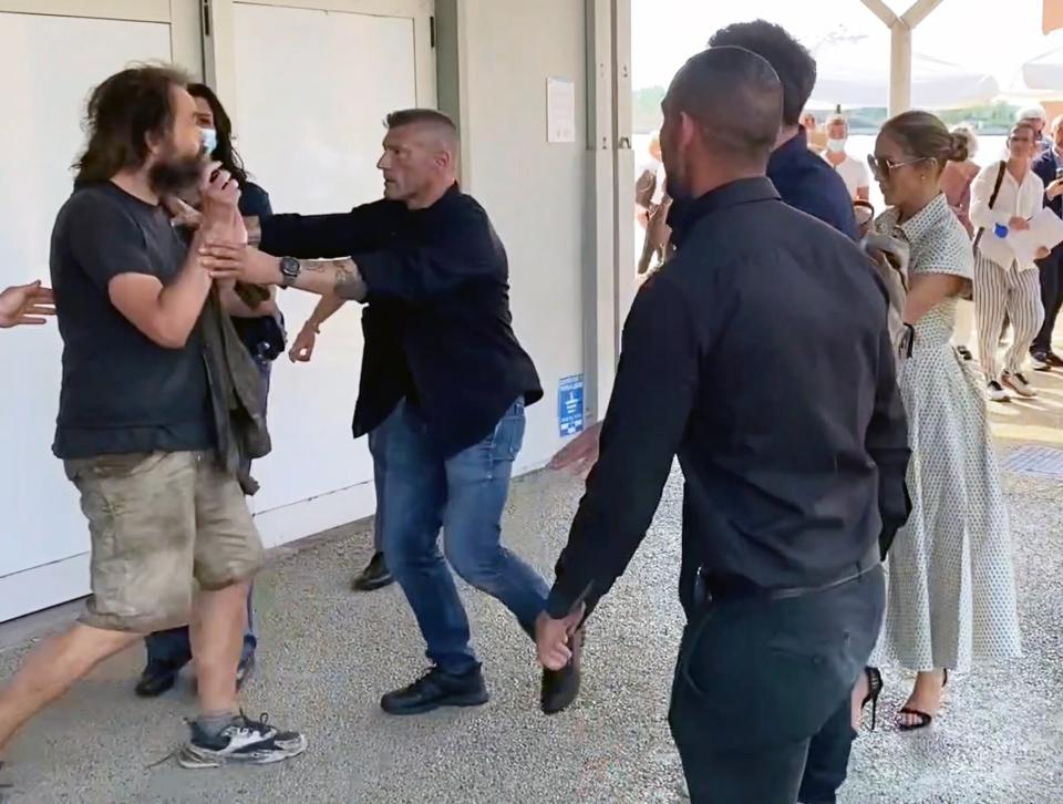 09/11/2021 EXCLUSIVE: Ben Affleck pushes away a fan who tries to take a photo with Jlo in Venice. The 49 year old American actor who is attending the Venice film festival with Lopez was spotted pushing away a male at an airport as a fan attempted to take a selfie with the couple.