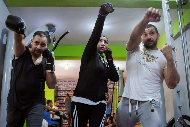 Sabah Saqr, an Egyptian boxing coach challenges social boundaries by training men, is seen during a training session at the gym, in Bani Swief