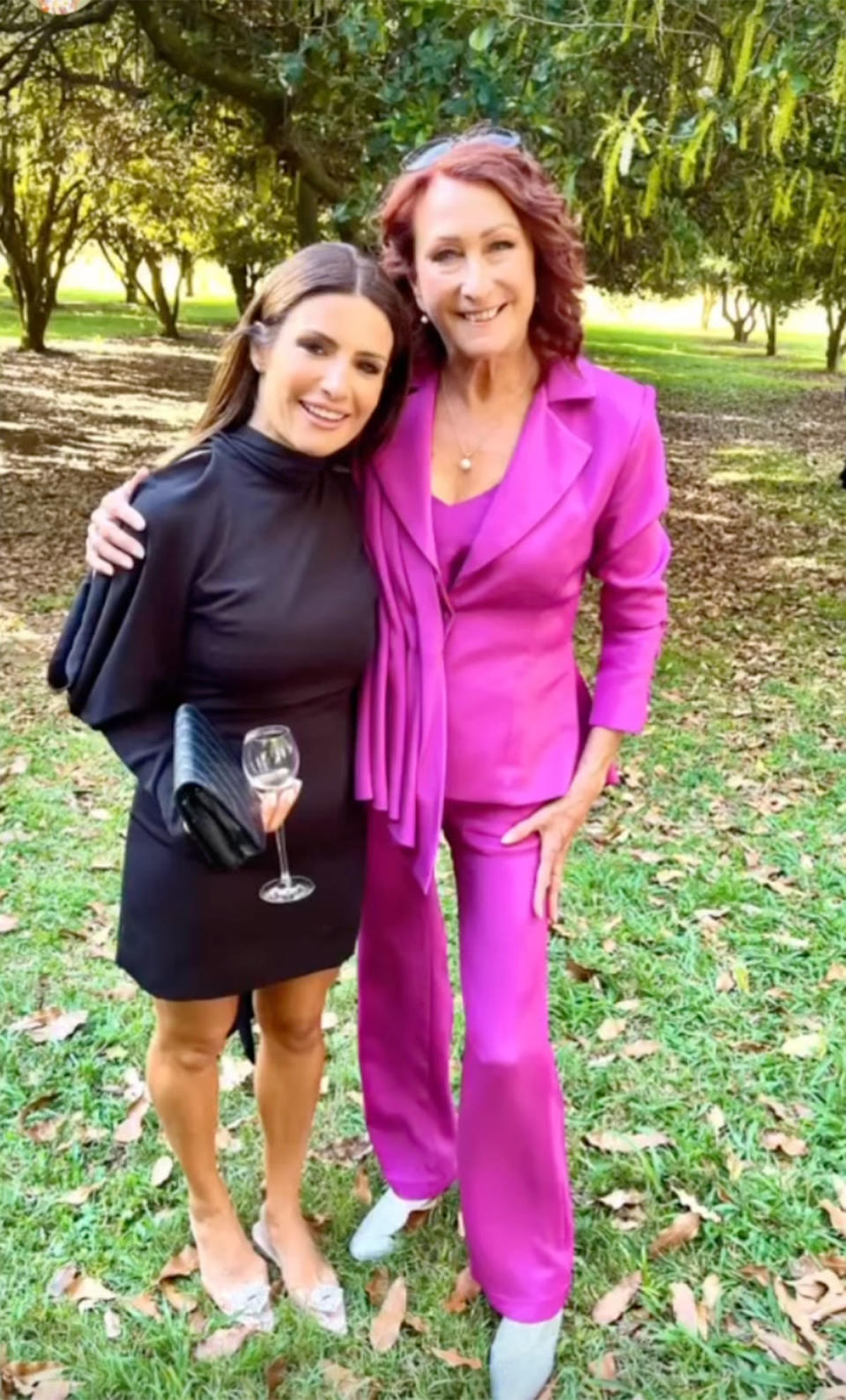 Ada Nicodemou in black and Lynne McGranger in a pink pant suit outside