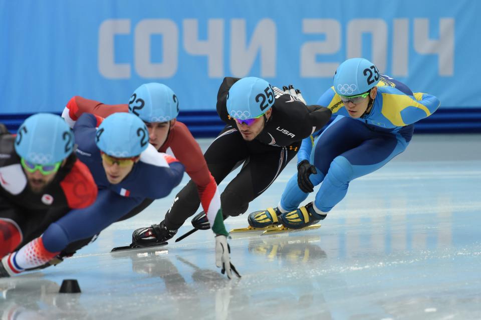 Eduardo Alvarez (USA), center, races in the mens 1500m short track speed skating heats during the Sochi 2014 Olympic Winter Games at Iceberg Skating Palace on Feb. 10, 2014.