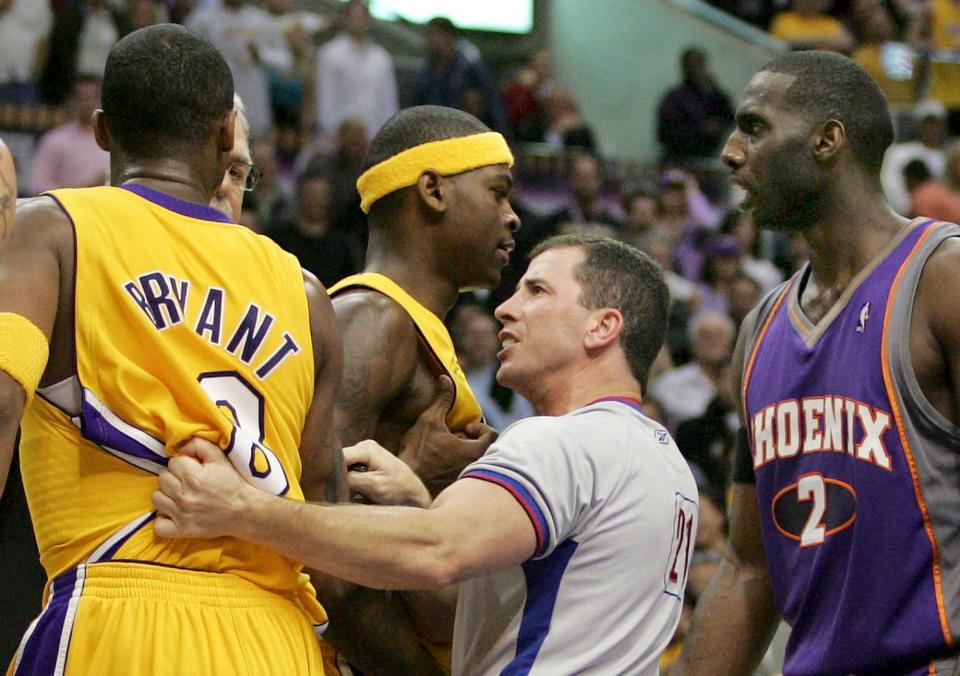 This file photo shows NBA official Tim Donaghy separating Kobe Bryant and Los Angeles Lakers players from Phoenix Suns players during the second half of their 2006 first-round playoff game in Los Angeles.