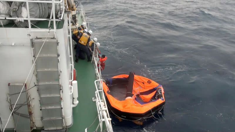 Filipino crew member of Gulf Livestock 1 is rescued by Japan Coast Guard crew on vessel Kaimon, at the East China Sea