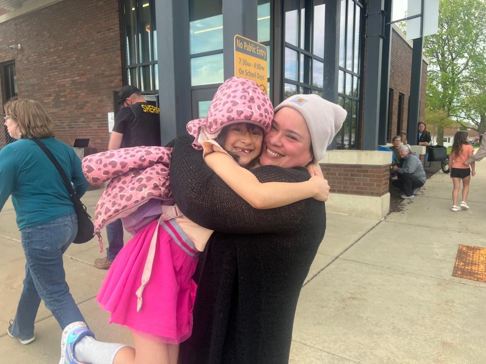 Aurora Powers, a Mount Horeb mother, reunites with her daughter after students spent hours locked in their schools following a report of an active shooter at the Mount Horeb Middle School.