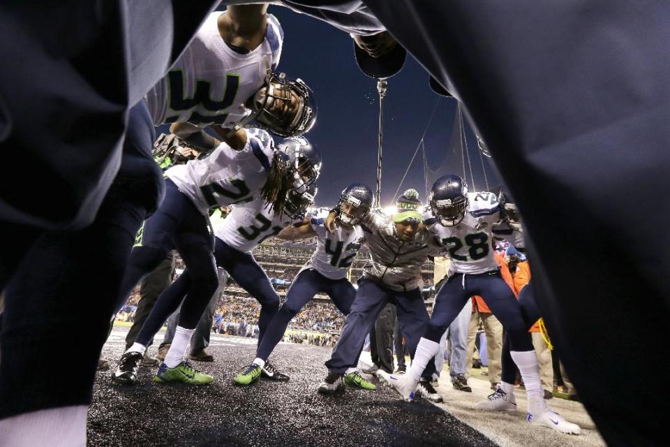 Members of the Seattle Seahawks huddle before the NFL Super Bowl XLVIII football game against the Denver Broncos on Sunday, Feb. 2, 2014, in East Rutherford, N.J. (AP Photo/Julio Cortez)