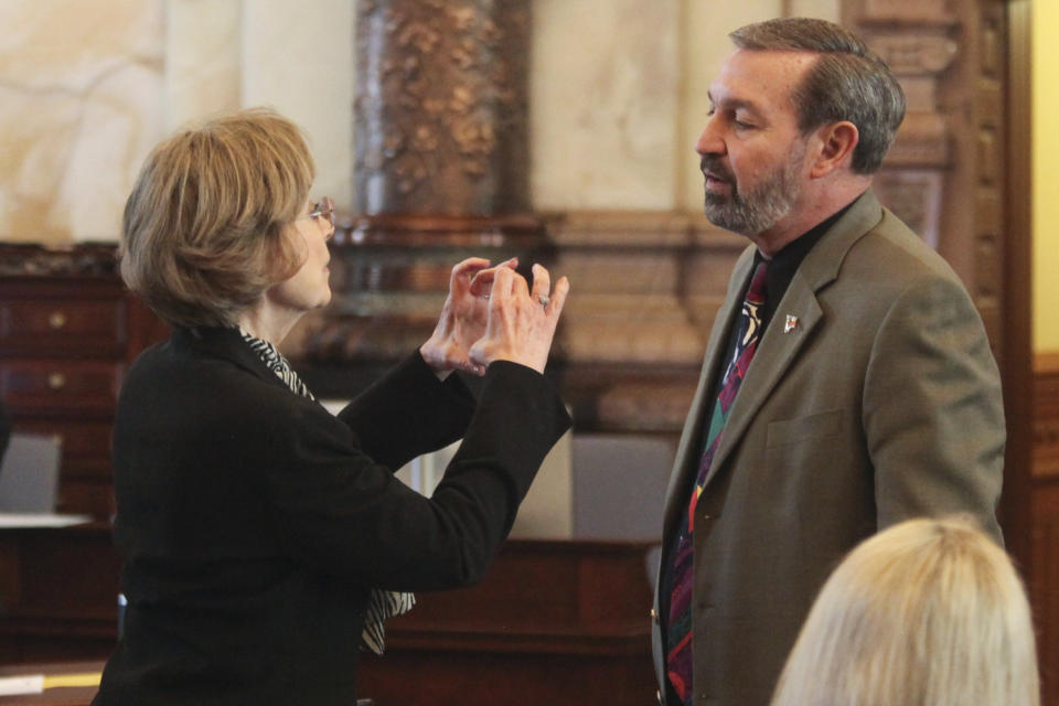 Kansas state Sens. Beverly Gossage, left, R-Eudora, and Virgil Peck, right, R-Havana, confer ahead of a debate on a bill that would eliminate the extra three days after an election that voters have to return their mail ballots, Monday, March 4, 2024, at the Statehouse in Topeka, Kansas. Both senators support provisions added to the bill to ban remote ballot drop boxes and the use of machines in tabulating votes. (AP Photo/John Hanna)