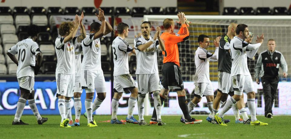 Swansea City acknowledge their fans after their English Premier League soccer match against Stoke City, at the Liberty Stadium in Swansea, Wales, November 10, 2013.