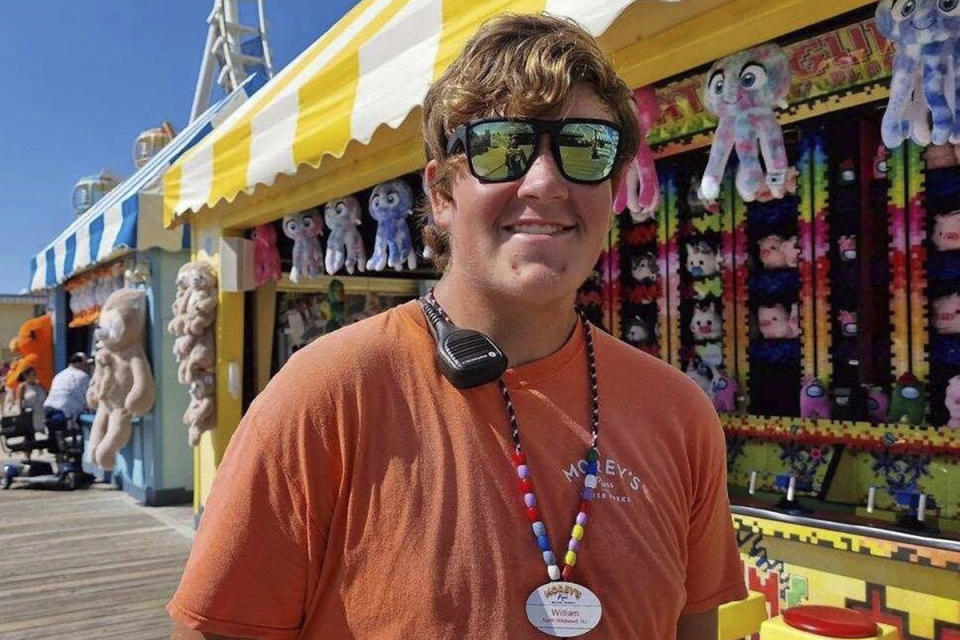 This undated photo provided by Sally Rutherford, Billy Rutherford poses in Wildwood, N.J. Rutherford, 17, works at Morey’s Piers amusement park as a game operator. He took advantage of a 2022 New Jersey law change that allowed 16- and 17-year-olds to work up to 50 hours a week during the summer, his mother Sally Rutherford said. (Sally Rutherford via AP)