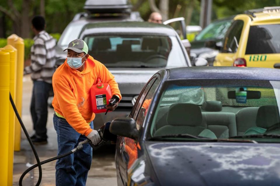 Customers fill up their automobiles and gas containers with fuel at the Circle K on Avent Ferry Road on Wednesday, May 12, 2021 in Raleigh, N.C. The cyberattack on the Colonial Pipeline has spread fears of a gas shortage, with long lines forming at stations that have a supply.