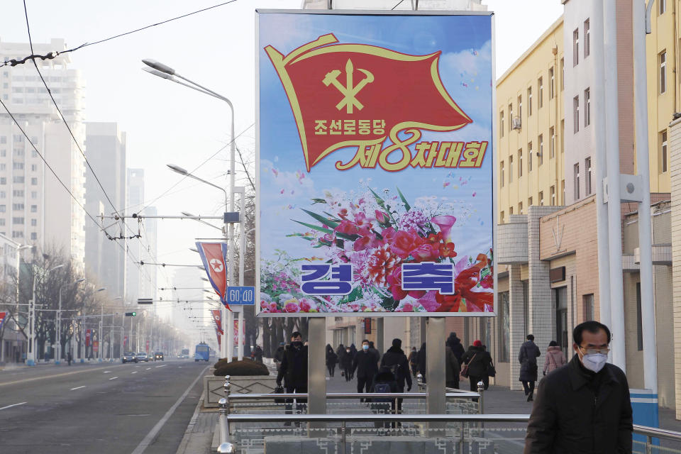 People walk past a billboard announcing the 8th Congress of the Workers' Party along a main street of the Central District in Pyongyang, North Korea, on Wednesday, Jan., 6, 2021. The Workers’ Party Congress is one of the North’s biggest propaganda spectacles and is meant to help leader Kim Jong Un show his people that he’s firmly in control and boost unity in the face of COVID-19 and other growing economic challenges. (AP Photo/Cha Song Ho)