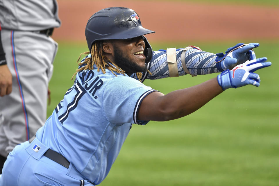 Toronto Blue Jays' Vladimir Guerrero Jr. gestures toward the dugout after hitting a triple against the Miami Marlins during the first inning of a baseball game in Buffalo, N.Y., Wednesday, June 2, 2021. (AP Photo/Adrian Kraus)