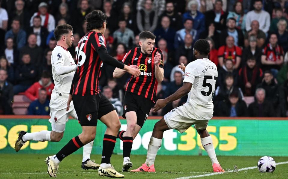 Ryan Christie is about to be fouled by Willy Kambwala.