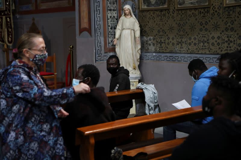 Refugees and migrants attend Holy Mass a day before the visit of Pope Francis on the island of Lesbos