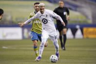 FILE - Minnesota United midfielder Emanuel Reynoso dribbles against the Seattle Sounders during the second half of an MLS playoff Western Conference final soccer match in Seattle, in this Monday, Dec. 7, 2020, file photo. Reynoso is being talked about as a potential breakout star for the upcoming Major League Soccer season.(AP Photo/Ted S. Warren, File)