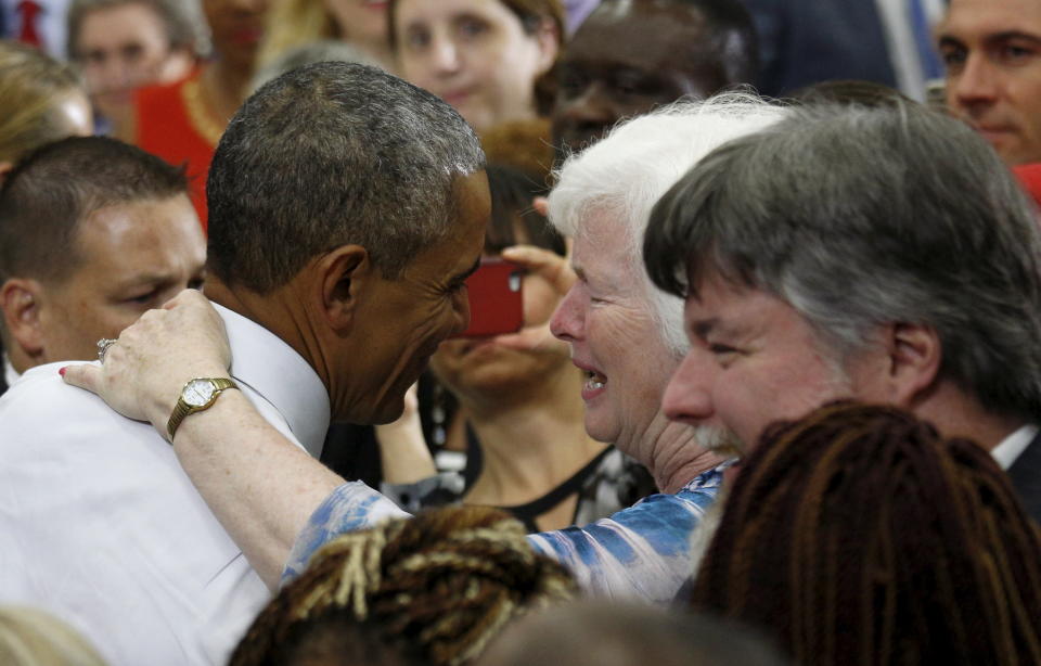 U.S. President Barack Obama (L) receives a hug after speaking about the Affordable Care Act during a visit to Taylor Stratton Elementary School in Nashville, Tennessee July 1, 2015. REUTERS/Kevin Lamarque 