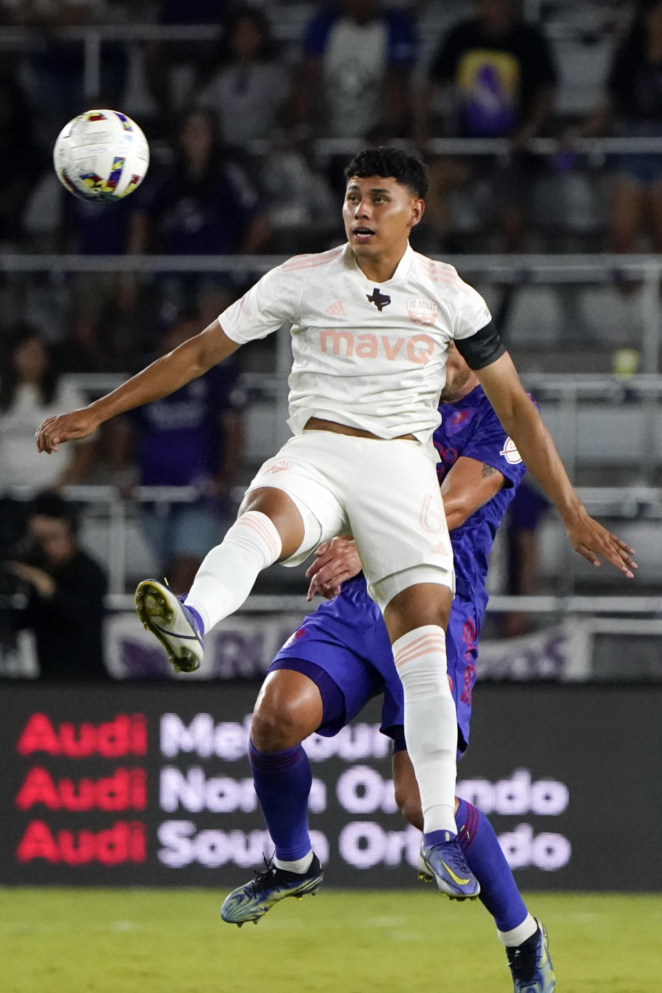 FC Dallas midfielder Edwin Cerrillo (6) jumps in front of Orlando City defender Robin Jansson for possession of the ball during the second half of an MLS soccer match, Saturday, May 28, 2022, in Orlando, Fla. (AP Photo/John Raoux)