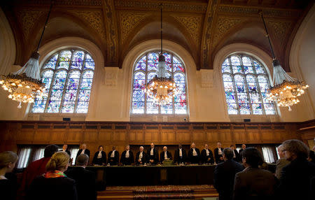FILE PHOTO: International Court of Justice (ICJ) President and presiding judge Hisashi Owada (8th L) and other judges attend the start of a hearing on Costa Rica's border dispute with Nicaragua at the ICJ peace palace in The Hague, Netherlands, March 8, 2011. REUTERS/Jerry Lampen/File Photo