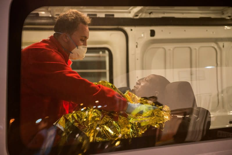 A member of the Spanish Red Cross helps a migrant, after a rescue action off the coast at the Mediterranean Sea, at the port of the Spanish North African enclave of Melilla