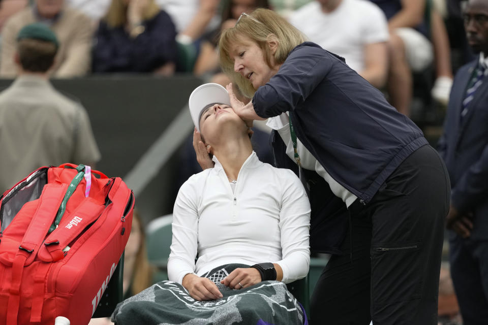 Anna Kalinskaya of Russia receives medical treatment during her fourth round match against Elena Rybakina of Kazakhstan at the Wimbledon tennis championships in London, Monday, July 8, 2024. (AP Photo/Kirsty Wigglesworth)