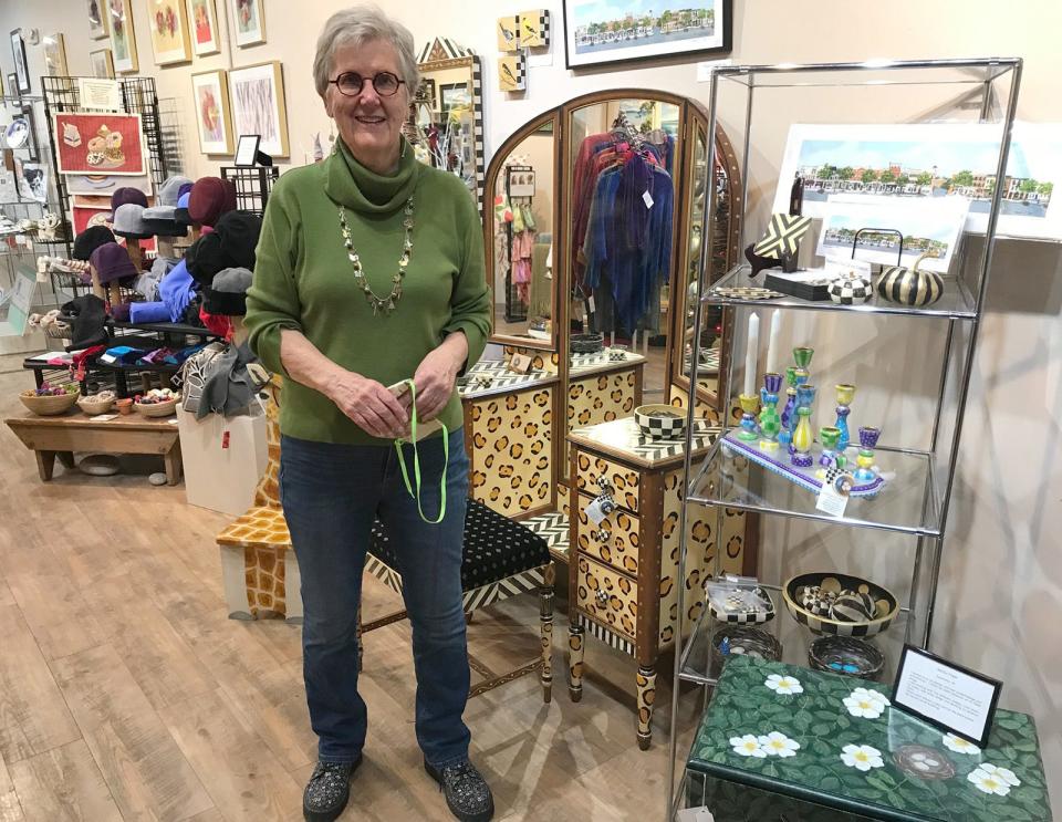 Marilyn Fegan of Cazenovia poses Dec. 2 in front of her booth at Cazenovia Artisans, where she has both Christmas and Hannukah gift items she has handcrafted. 