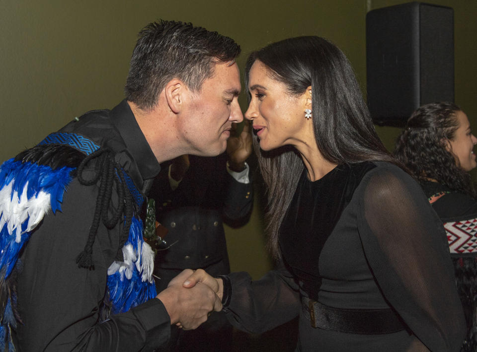 Meghan Markle was caught on camera giggling during a traditional Māori greeting in London yesterday. Photo: Getty Images