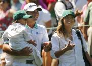 Jason Day of Australia walks with his wife Ellie and son Dash as he particapates in the par 3 event held ahead of the 2015 Masters at Augusta National Golf Course in Augusta, Georgia April 8, 2015. REUTERS/Mark Blinch