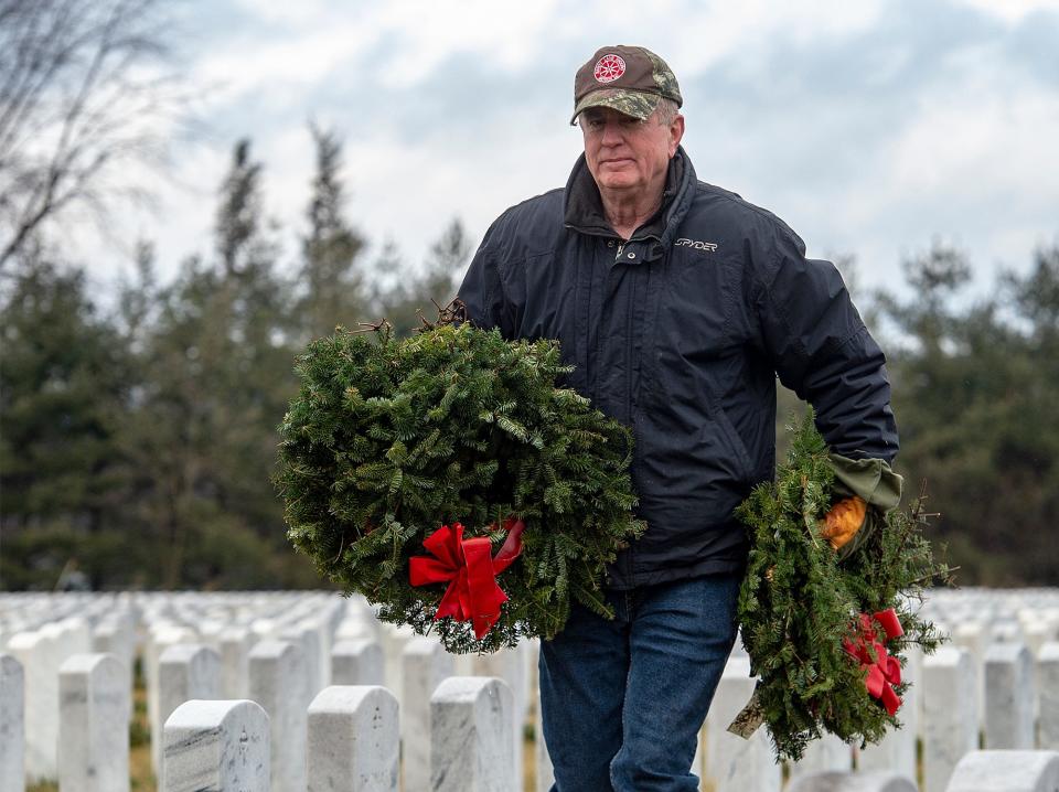 Dave Coulston, of New Hope, does his part in removing wreaths from the gravesites of veterans buried at Washington Crossing National Cemetery in Upper Makefield on Monday, Jan. 17, 2022.