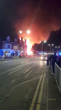 Flames leap into the sky from the site of an explosion in Leicester, Britain, February 25, 2018 in this still image taken from a video obtained from social media. FACEBOOK/GRAEME HUDSON/via REUTERS