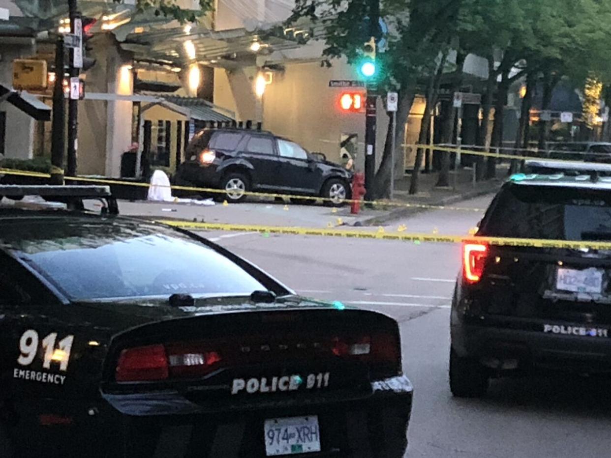 A crashed SUV is shown behind police lines following a collision that killed a toddler and injured her father in downtown Vancouver on July 6, 2021. (James Mulleder/CBC News - image credit)