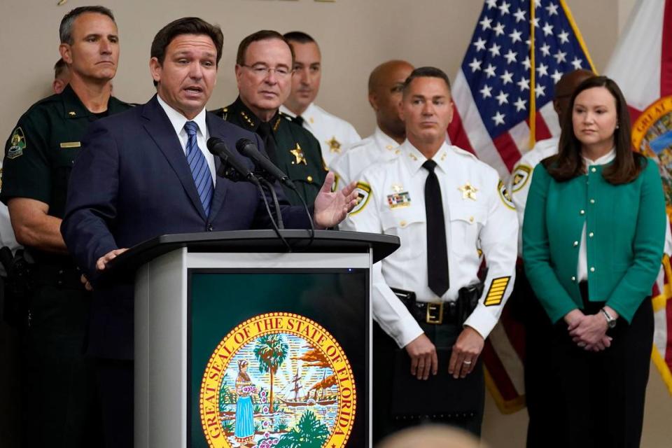 Florida Gov. Ron DeSantis, surrounded by members of law enforcement, gestures as he speaks during a news conference Thursday, Aug. 4, 2022, in Tampa, Fla. DeSantis announced that he was suspending State Attorney Andrew Warren.