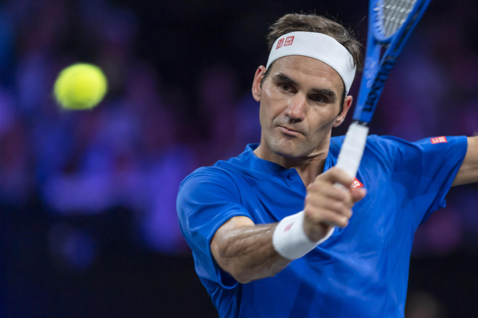 Team Europe's Roger Federer returns a ball to Team World's Nick Kyrgios during their match at the Laver Cup tennis event in Geneva, Switzerland, Saturday, Sept. 21, 2019. (Martial Trezzini/Keystone via AP)