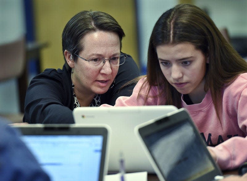 Jennifer Rocca, left, a teacher librarian at Brookfield, Conn., High School, left, works Dec. 20 with Ariana Mamudi, 14, a freshman in her Digital Student class. The required class teaches media literacy skills and has the students scrutinize sources for their on-line information. California schools are now required to teach students how to recognize fake news by incorporating media literacy into lessons.