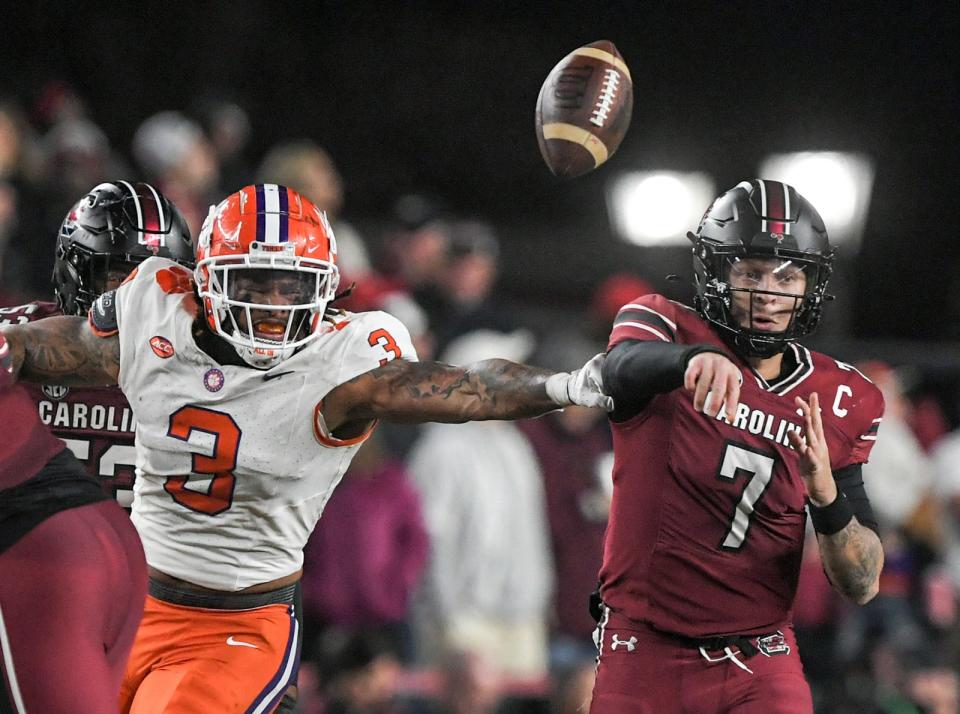 Clemson defensive end Xavier Thomas (3) breaks up a pass by South Carolina quarterback Spencer Rattler (7) during a game on Nov. 25, 2023.