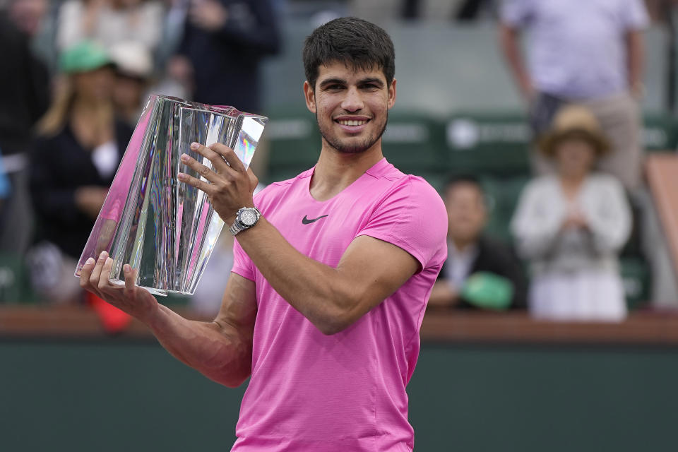 Carlos Alcaraz, of Spain, holds the winner's trophy after defeating Daniil Medvedev, of Russia, in the men's singles final at the BNP Paribas Open tennis tournament Sunday, March 19, 2023, in Indian Wells, Calif. (AP Photo/Mark J. Terrill)