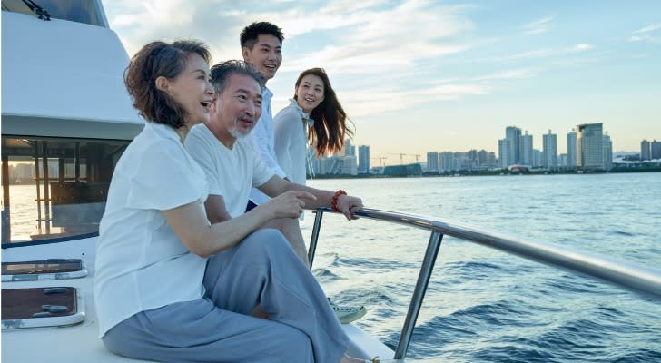 A wealthy family enjoys the view from their yacht. 