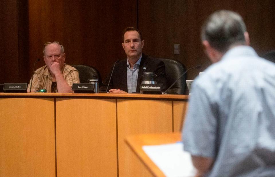 State College Borough Council President Jesse Barlow and State College Mayor Ezra Nanes listen during Monday’s Borough Council meeting to resident Evan Myers talk about the antisemitic messages that were found in his neighborhood.