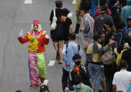 A pro-democracy protester dresses as clown during a protest near a main train station in Bangkok, Thailand, Saturday, Oct. 17, 2020. The authorities in Bangkok shut down mass transit systems and set up roadblocks Saturday as Thailand's capital braced for a fourth straight day of determined anti-government protests. (AP Photo/Sakchai Lalit)