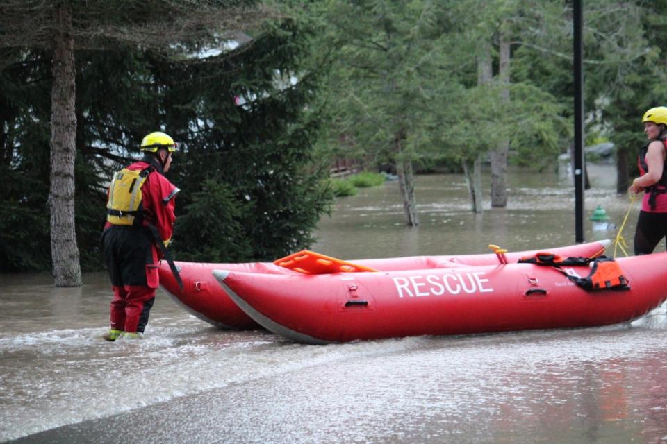 Volunteers carry rescue kayaks at the scene of flooding at Labar Village in Stroudsburg on Tuesday, Aug. 4, 2020 after Tropical Storm Isaias ripped through the area.