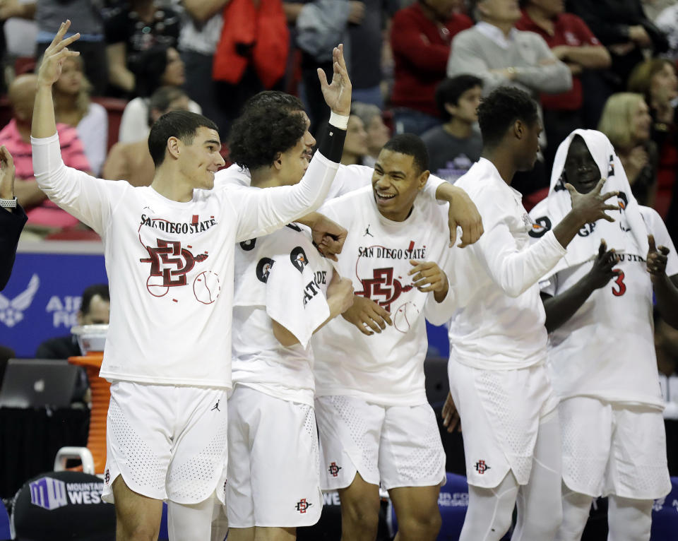 The San Diego State bench reacts during the second half of the team's NCAA college basketball game against Boise State in the Mountain West Conference men's tournament Friday, March 6, 2020, in Las Vegas. (AP Photo/Isaac Brekken)