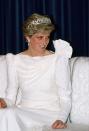 <p>At a state banquet in Bahrain, Princess Diana paired the famous <a href="https://www.townandcountrymag.com/style/jewelry-and-watches/a34669830/spencer-tiara-princess-diana-history/" rel="nofollow noopener" target="_blank" data-ylk="slk:Spencer Tiara;elm:context_link;itc:0;sec:content-canvas" class="link ">Spencer Tiara</a> with a ruffled-shouldered white dress. </p>