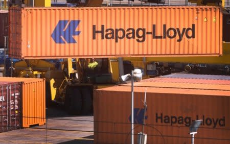 FILE PHOTO: A port worker moves a Hapag-Lloyd container at the Port of Bilbao on the second day of a three-day strike by Spanish port workers to protest the reform of operations, aimed at liberalising hiring practices, in Santurtzi, northern Spain, June 7, 2017. REUTERS/Vincent West/File Photo