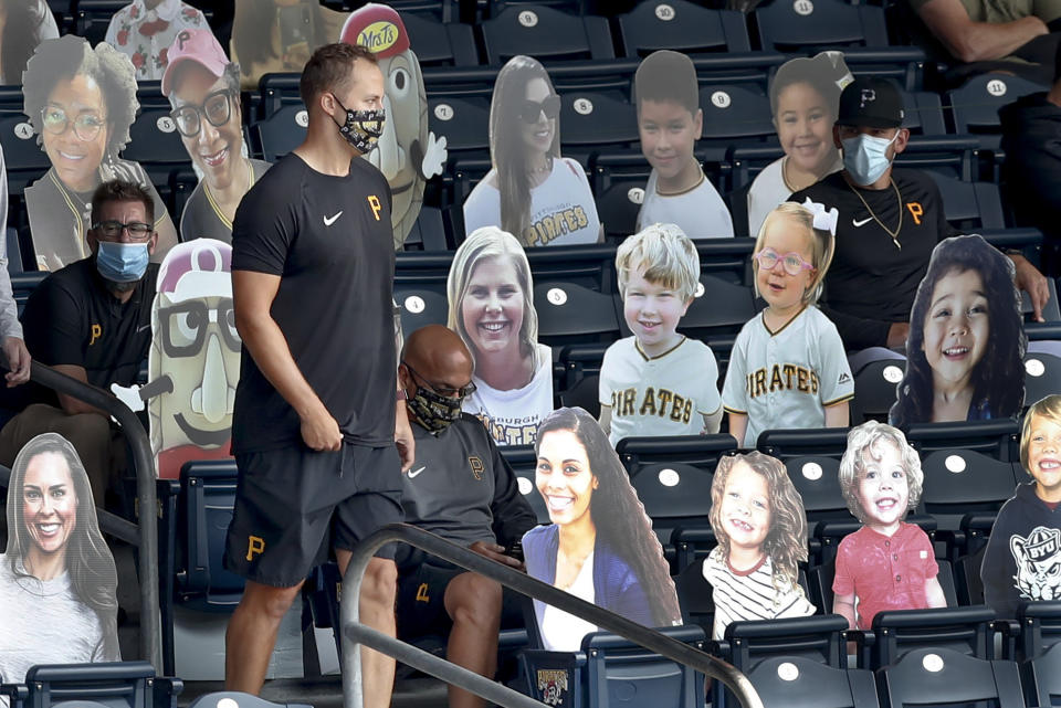 Injured Pittsburgh Pirates pitcher Jameson Taillon walks through the section with cutout images of fans in the stands at PNC Park before a baseball game against the Minnesota Twins, Thursday, Aug. 6, 2020, in Pittsburgh. (AP Photo/Keith Srakocic)