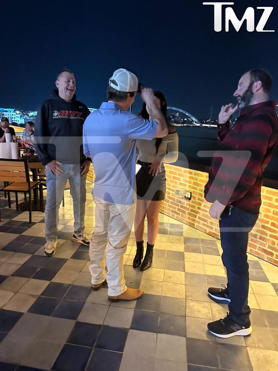 morgan wallen is seen chatting with a woman ijn a group on a rooftop before the chair-throwing incident