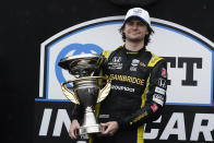 Colton Herta holds the trophy after winning an IndyCar auto race at Indianapolis Motor Speedway, Saturday, May 14, 2022, in Indianapolis. (AP Photo/Darron Cummings)