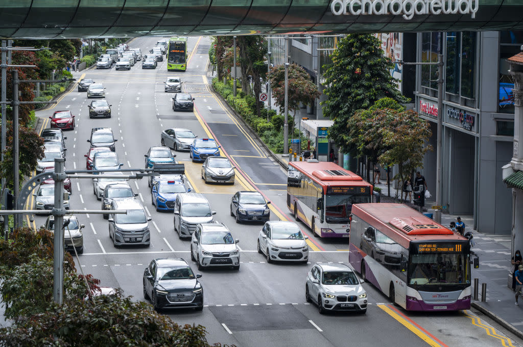 Cars and buses travel along Orchard Road in Singapore, illustrating a story on a separate COE category.