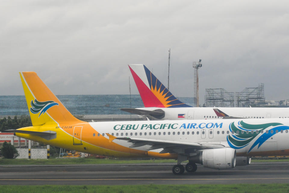 FILE PHOTO: Planes belonging to Cebu Pacific and Philippine Airlines, seen at Manila Ninoy Aquino International Airport onJuly 3, 2019, in Manila, Philippines. (Photo by Artur Widak/NurPhoto via Getty Images)